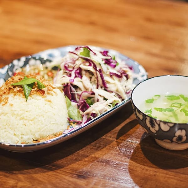 Hên Vietnamese Restaurant's chicken rice with shredded cabbage salad and a side of clear soup.